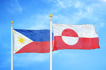 Philippines and Greenland two flags on flagpoles and blue cloudy sky