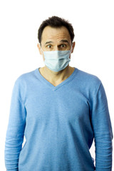 scared man in medical mask in fear of coronavirus stands in protective mask against viruses and infections isolated studio. Coronavirus 2019-ncov covid-19 concept.