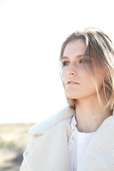 Fototapeta premium Close-up portrait of a beautiful young girl with a clean fresh face. Outdoor.Space for text.
