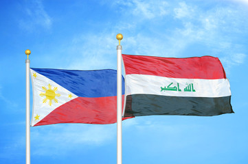 Philippines and Iraq two flags on flagpoles and blue cloudy sky