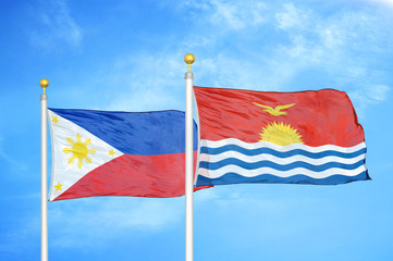 Philippines and Kiribati two flags on flagpoles and blue cloudy sky