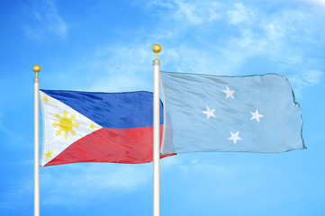Philippines and Micronesia two flags on flagpoles and blue cloudy sky