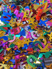 Confetti close up, various metallic  colors and shapes, horizontal background