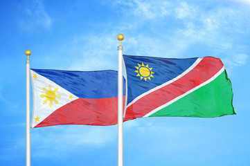 Philippines and Namibia two flags on flagpoles and blue cloudy sky
