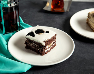 coffee cake topped with cream and chocolate syrup