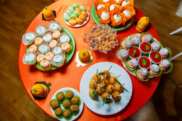sweets biscuits cake marshmallows and jelly on the festive table
