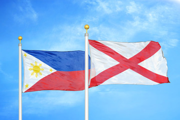 Philippines and Northern Ireland two flags on flagpoles and blue cloudy sky