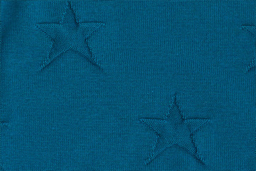 Blue knitted textured background with stars