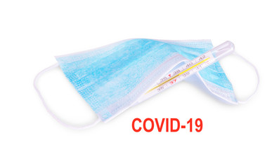 Covid 19 inscription, mask with a thermometer isolated on white background, covid-19 corona virus is sewn up, clinical treatment, medical background