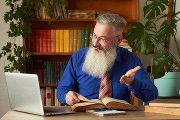 Distance Learning Concept. Teacher professor tutor teaches discipline online. Mature bearded man...