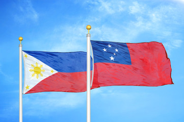 Philippines and Samoa two flags on flagpoles and blue cloudy sky