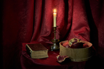 still life with candle, bible and pomegranate
