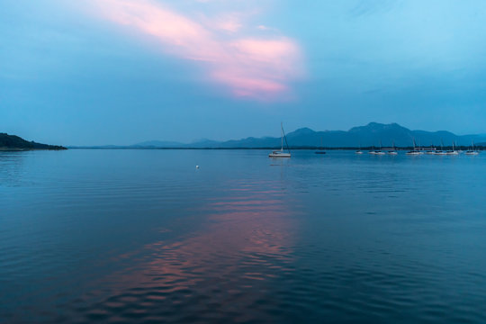 Scenic View Of Prien Am Chiemsee Lake Against Cloudy Sky During Sunset