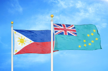 Philippines and Tuvalu two flags on flagpoles and blue cloudy sky