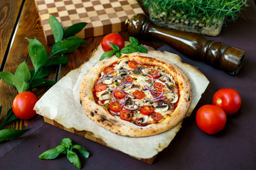 pizza with mozzarella cheese with tomatoes red onion and tenderloin
