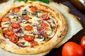 pizza with mozzarella cheese with tomatoes red onion and tenderloin