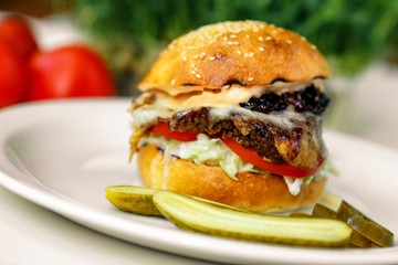 burger steak with spatula, mozzarella with onion and American sauce with cucumbers and jalapeno