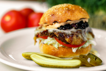 burger steak with spatula, mozzarella with onion and American sauce with cucumbers and jalapeno