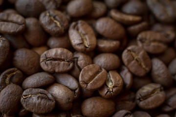 Extremely close-up background roasted coffee beans with gold streaks, good morning concept