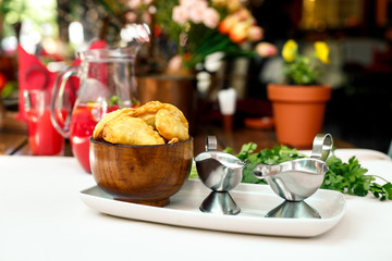Pastry with greens and sacks on a wooden surface