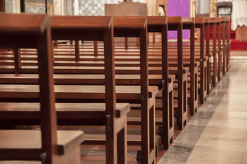 Detail of wooden benches inside a church