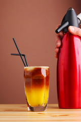 orange nitro coffee on wooden table closeup. Nitro cold brew coffee mixed with orange juice....