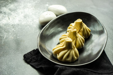 Traditional georgian khinkali dish on stone background