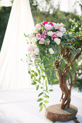 Wedding arch. Rustic wedding. Wedding area covered with flowers.