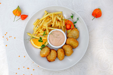 nuggets with French fries and sauce