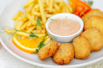 nuggets with French fries and sauce