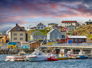 Fototapeta na wymiar Beautiful panoramic view of the Stykkisholmskirkja Harbor with Fishing ships (boats) at Stykkisholmur town in western Iceland. City view from Sugandisey Cliff with lighthouse. Famous colorful houses