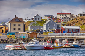 Beautiful panoramic view of the Stykkisholmskirkja Harbor with Fishing ships (boats) at Stykkisholmur town in western Iceland. City view from Sugandisey Cliff with lighthouse. Famous colorful houses - obrazy, fototapety, plakaty