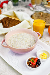 breakfast, oatmeal with butter, berries and orange juice