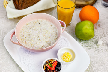 breakfast, oatmeal with butter, berries and orange juice