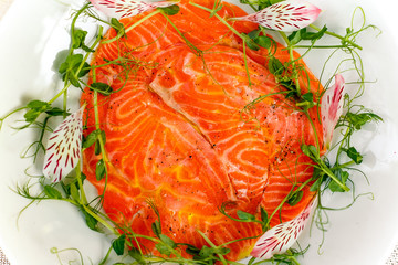 fillets of red fish with greens on a plate