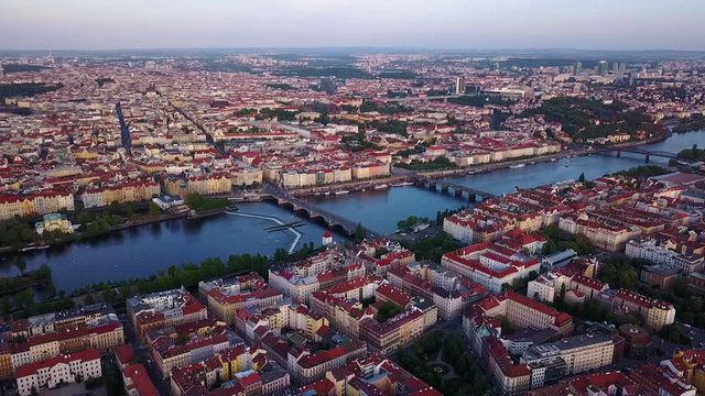 Panoramic aerial view of the city of Prague. The picture shows the roofs of buildings, streets, a river and bridges.