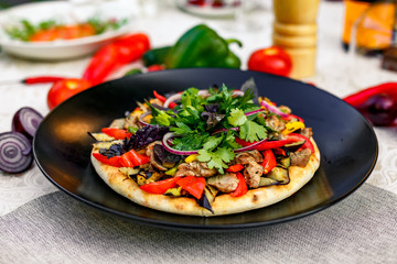 salad with meat greens and vegetables grilled on a wheat cake with smoke