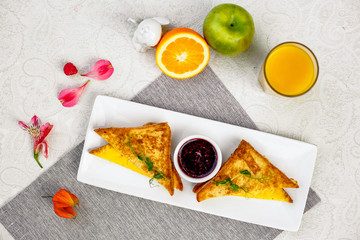 Toast with cheese and raspberry jam for breakfast