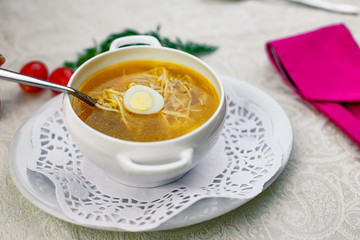 chicken soup with noodles and eggs with vegetables serving for lunch