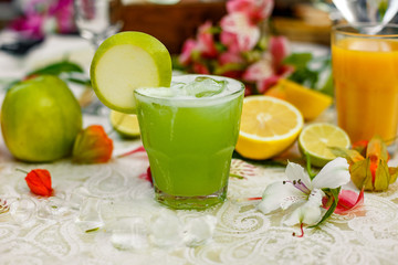 cocktail with apple and fruit on background