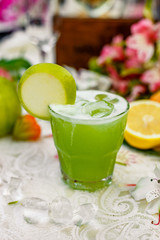 cocktail with apple and fruit on background