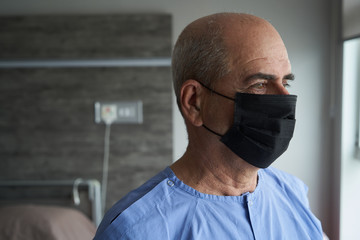 Portrait of an old man, 70 years old, in a medical mask