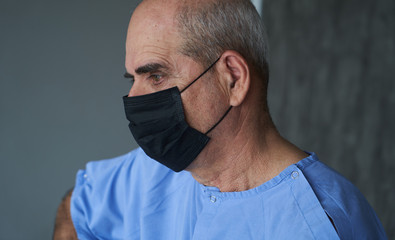 Fototapeta premium Senior man wearing face mask during corona virus and flu outbreak