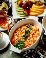 fried eggs with tomato and herbs with black tea