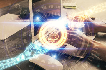 Double exposure of woman hands typing on computer and crypto market theme hologram drawing....