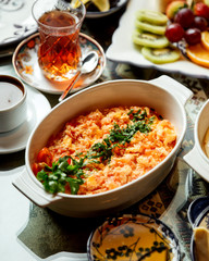 fried eggs with tomato with tea in armudu glass