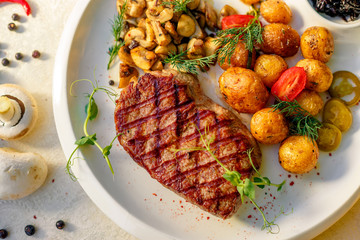delicious steak with mushrooms and baked potatoes with jalapeno, healthy food