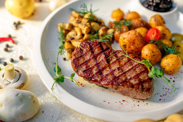 delicious steak with mushrooms and baked potatoes with jalapeno, healthy food