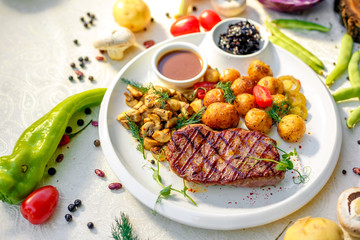 delicious steak with mushrooms and baked potatoes with jalapeno, healthy food