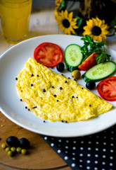 fried eggs with sliced cucumber and tomato